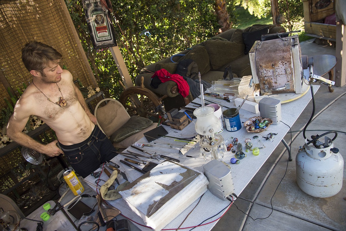 Glass artist, Alexander Chacona is looking at the set up in-front of him; a full table with all the tools ready to be part of what's about to go down.