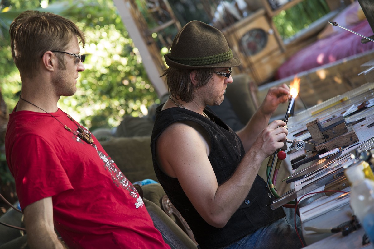 Alexander Chacona looking at the nice detail Corey Mitchell is applying to the piece of glass with the torch flame.