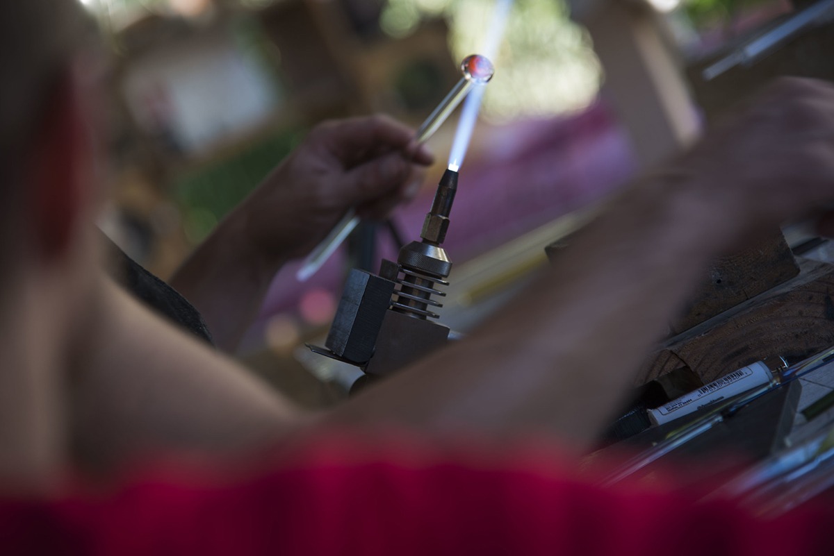 Close-up of the flame, molding and giving a new form to a piece of glass.